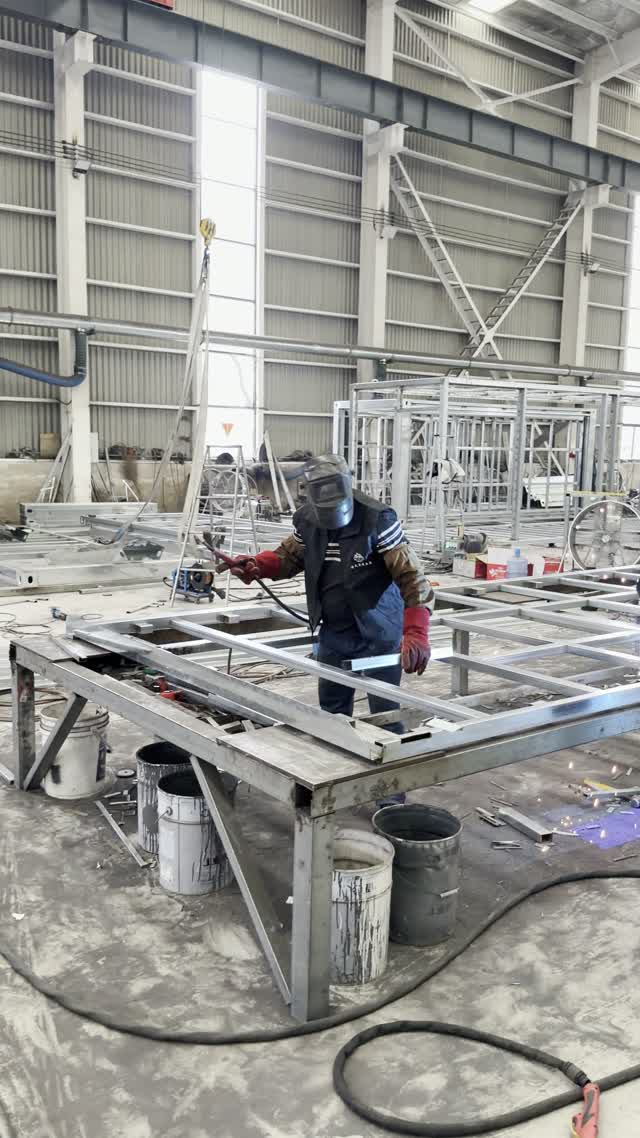 Worker fabricating a steel floor frame